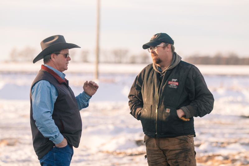 Bud conducting business of selling bred cattle by talking with another rancher.
